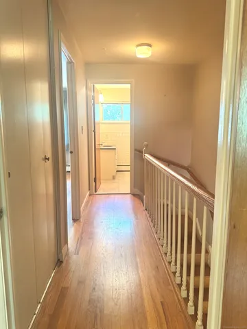 a view of a hallway with wooden floor