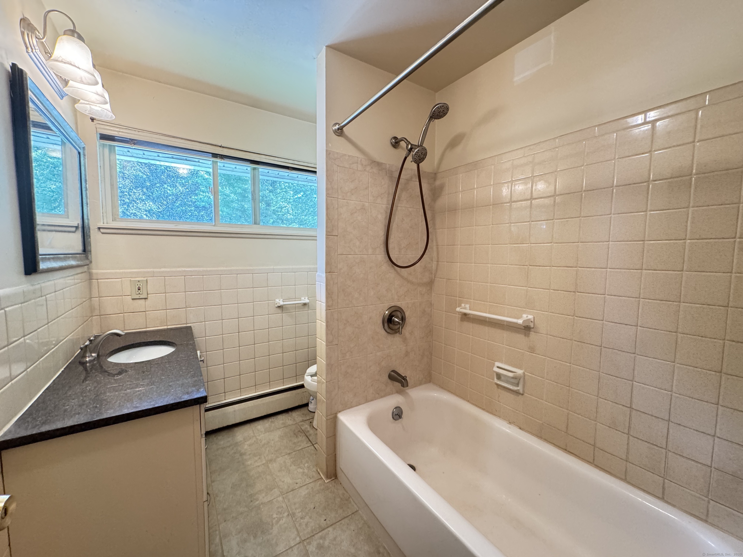 141 Worth Avenue Hamden, CT 06518 - Photo 9 of 17 a bathroom with a tub a sink and a window