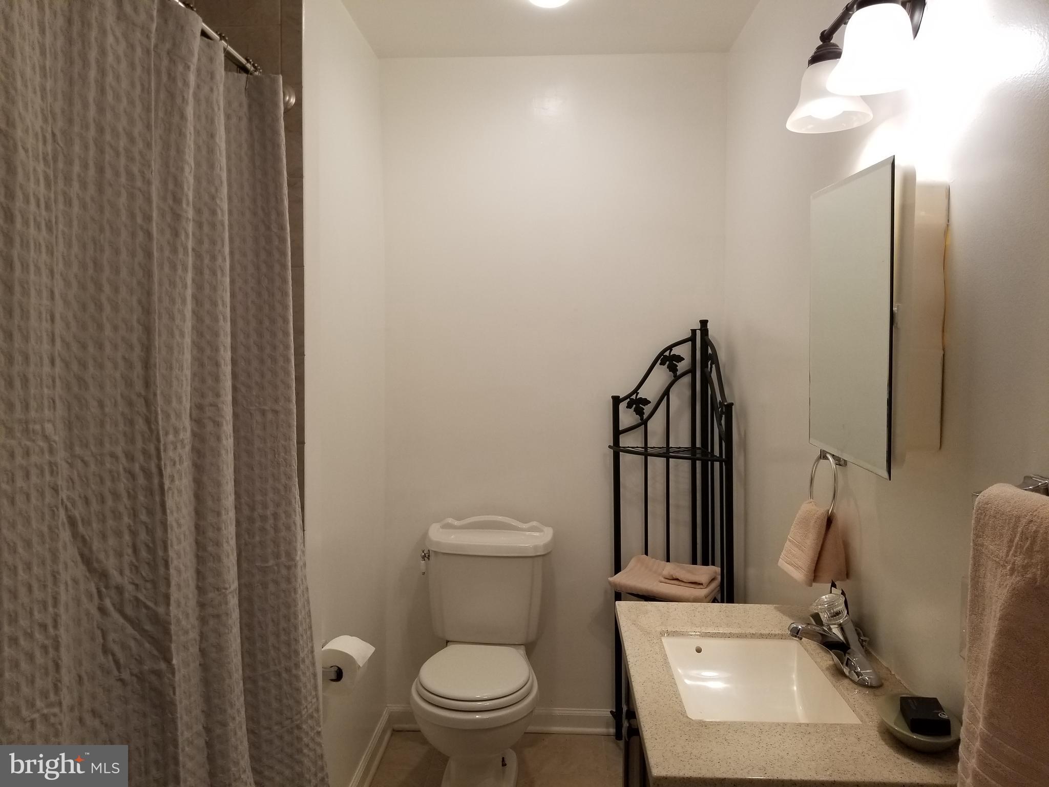 2821 7th Street Northeast Washington, DC 20017 - Photo 3 of 7 a bathroom with a toilet a sink and mirror