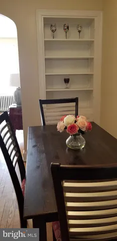 a view of a dining room with furniture and a potted plant