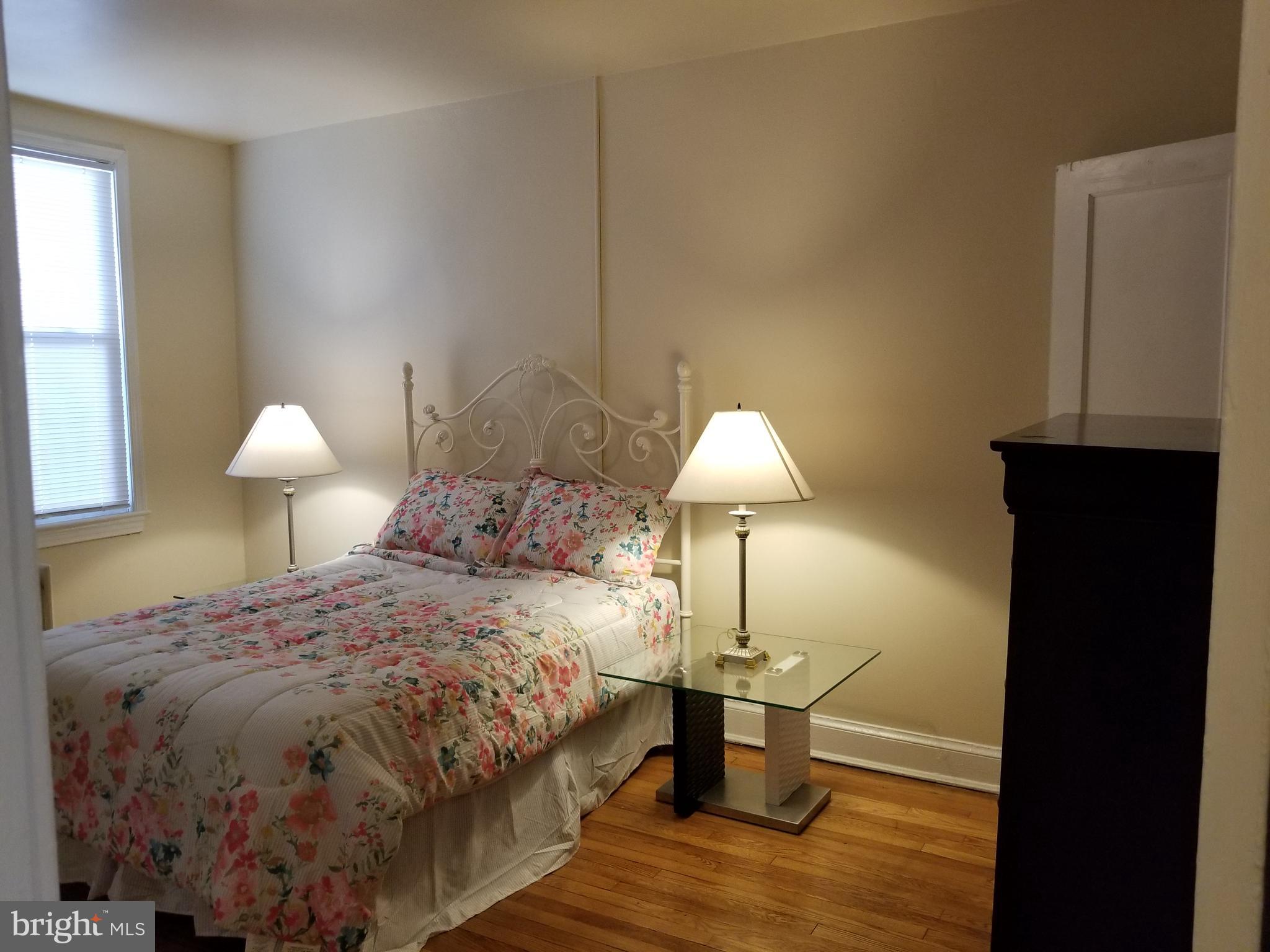 2821 7th Street Northeast Washington, DC 20017 - Photo 6 of 7 a bed room with a bed and a lamp