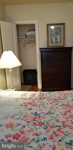 a room with a bed and a dresser