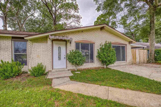 a view of a yard in front view of a house and garage