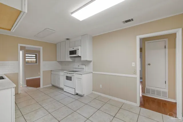 a kitchen with granite countertop cabinets and steel stainless steel appliances
