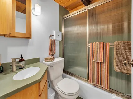a bathroom with a sink toilet and shower