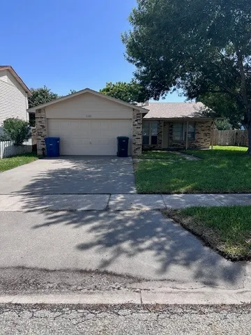 a front view of a house with a garden and yard