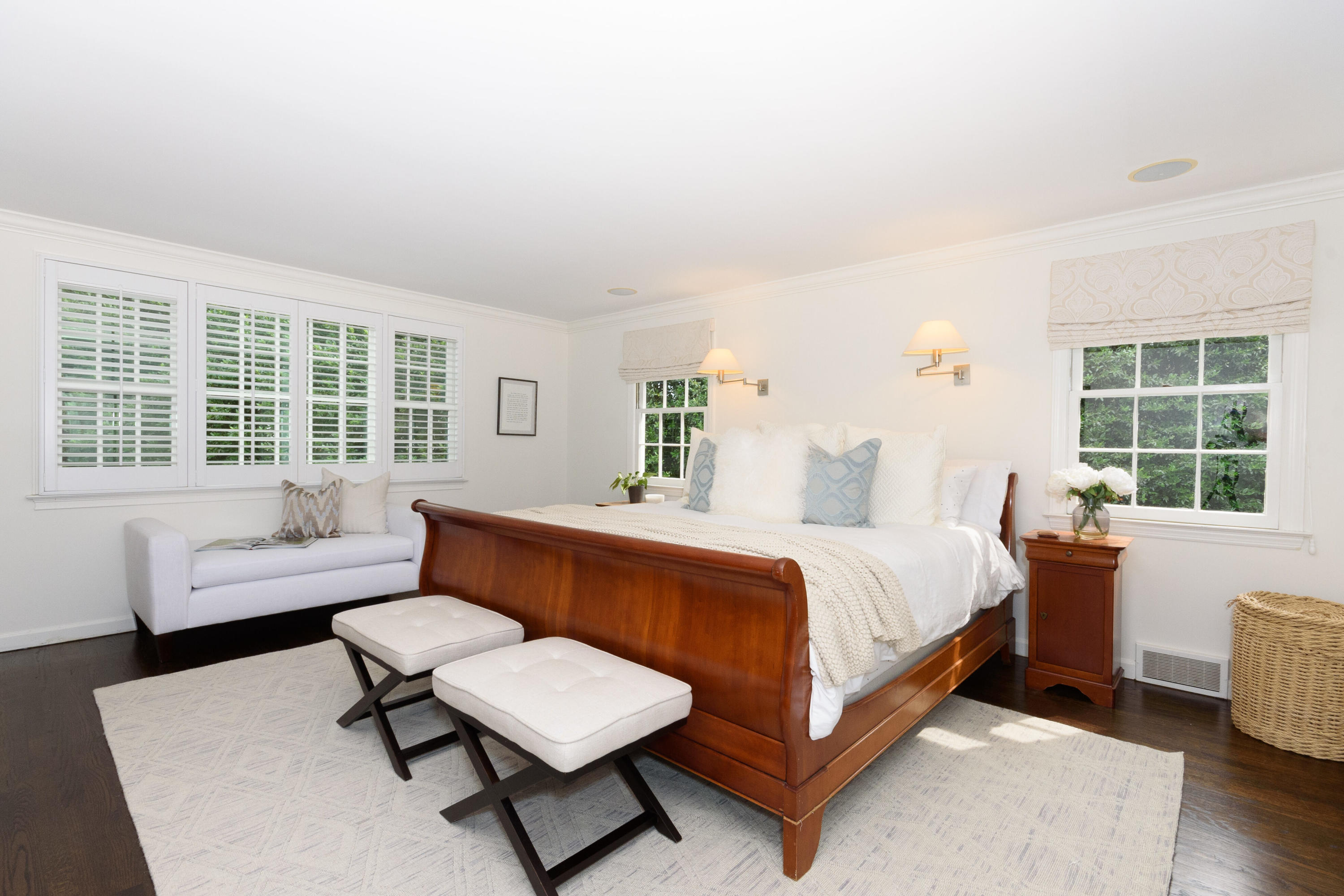 48 Long Neck Point Road Darien, CT 06820 - Photo 22 of 46 a spacious bedroom with a bed and a couch next to a window