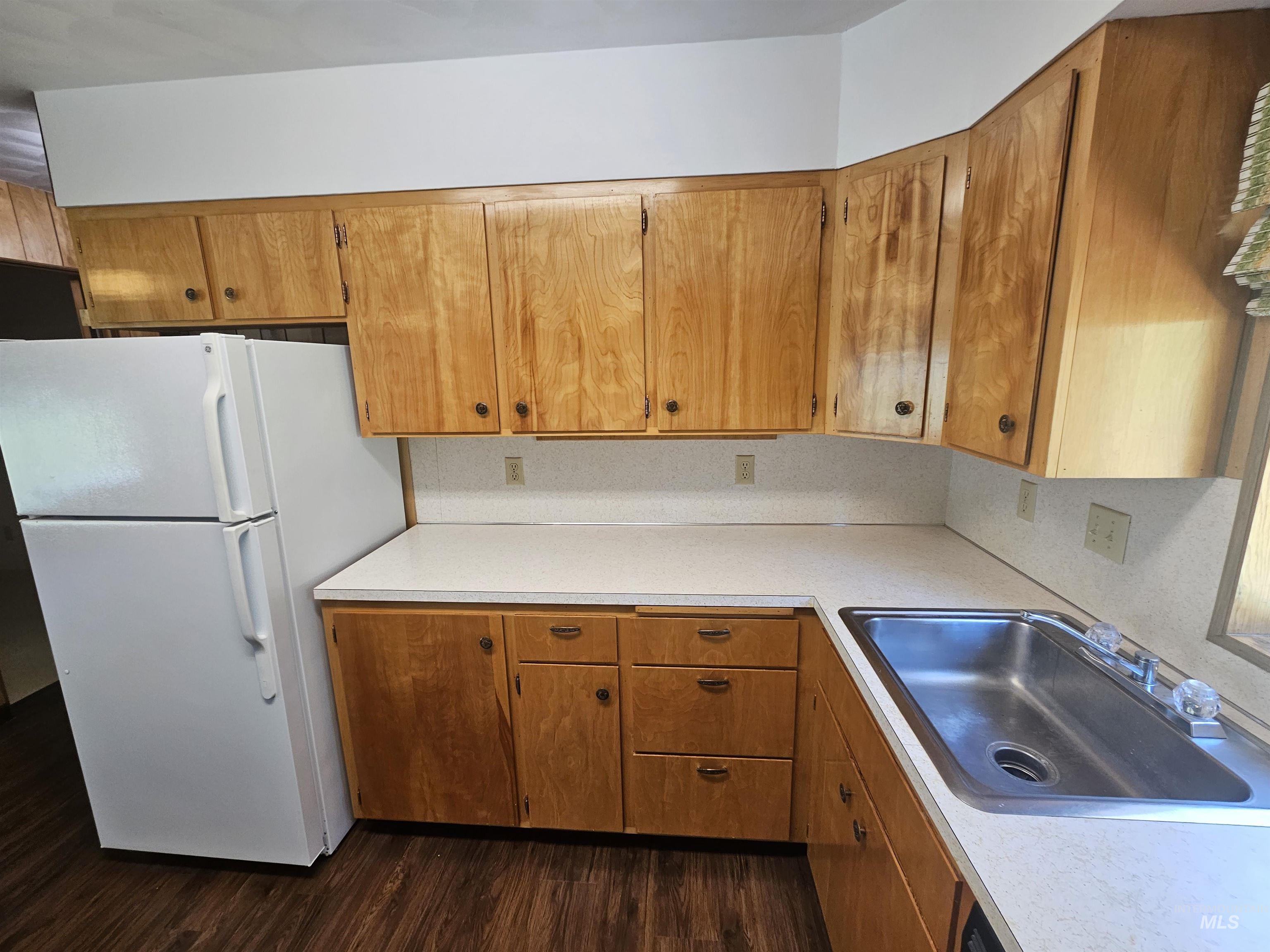 29865 Mission Creek Road Culdesac, ID 83524 - Photo 11 of 43 Kitchen featuring wood-finish cabinetry, light-toned countertops, and a double basin stainless steel sink