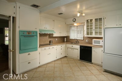 1852 Alpha Road Glendale, CA 91208 - Photo 4 of 13 a kitchen with a refrigerator sink and cabinets