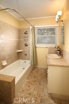 1852 Alpha Road Glendale, CA 91208 - Photo 7 of 13 a bathroom with a granite countertop sink a large mirror and a bathtub
