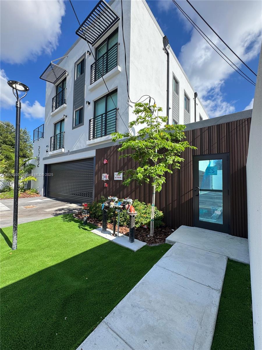 2782 Northwest 46th Street, Unit 5 Miami, FL 33142 - Photo 1 of 18 a view of a porch with a yard