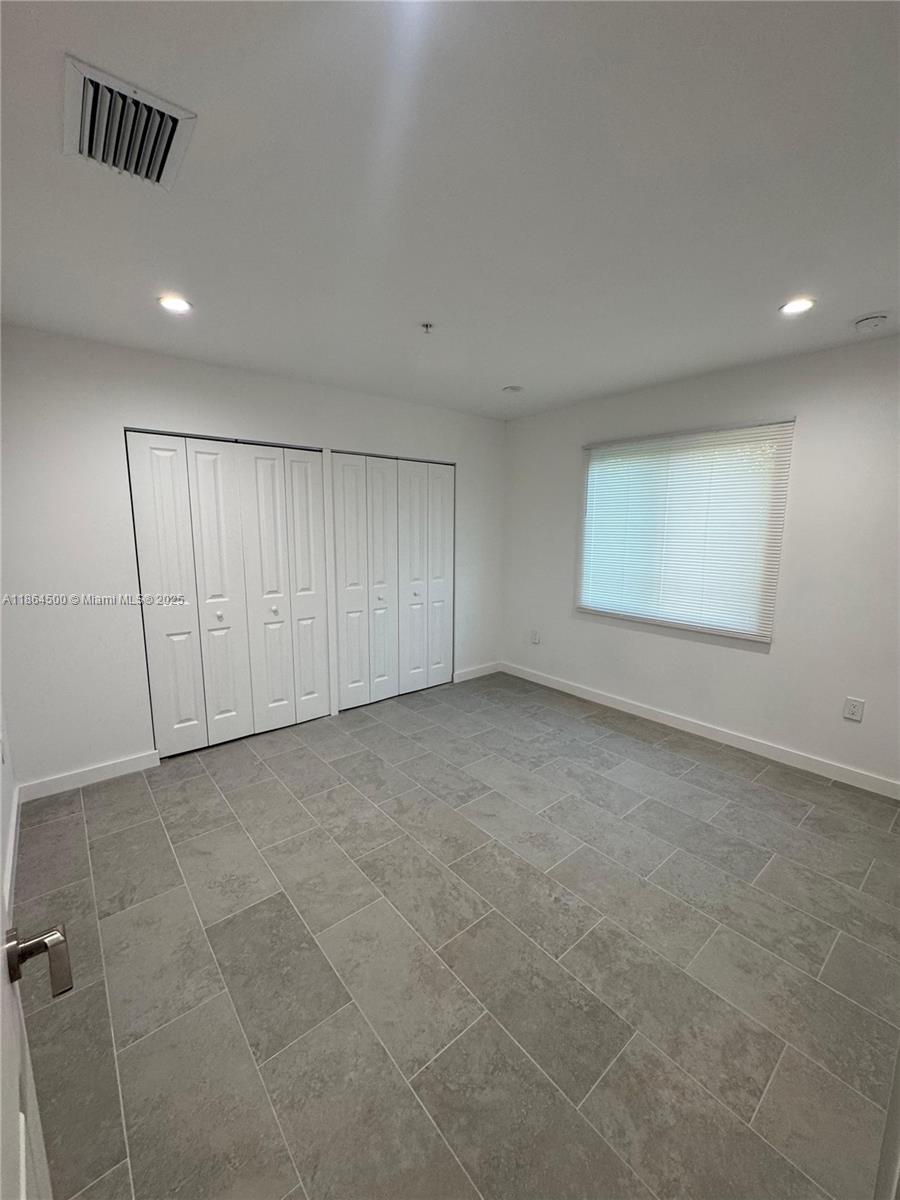 2782 Northwest 46th Street, Unit 5 Miami, FL 33142 - Photo 10 of 18 a view of an empty room with a window