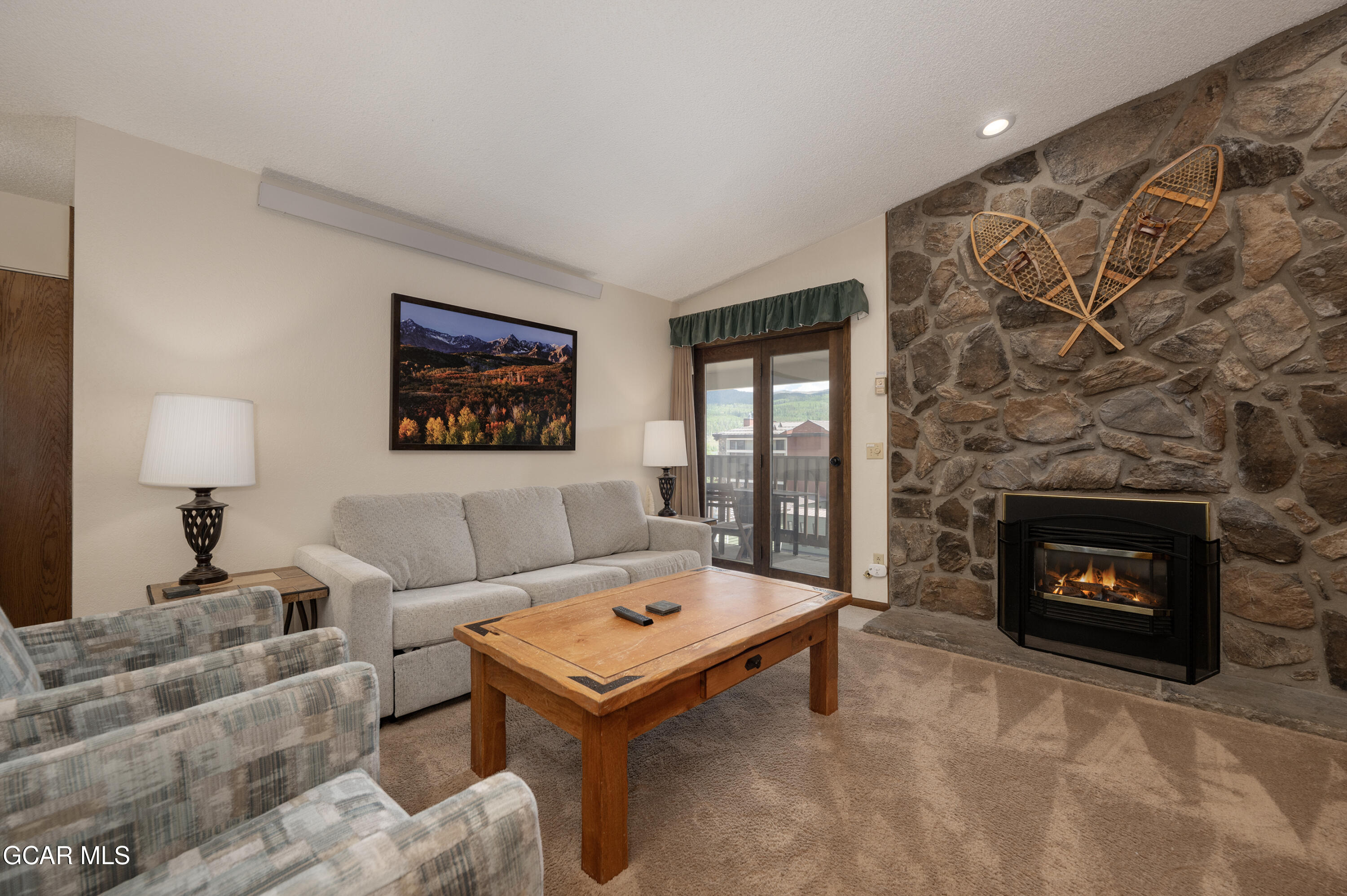 490 Kings Crossing Road, Unit 331 Winter Park, CO 80482 - Photo 2 of 38 a living room with furniture and a fireplace