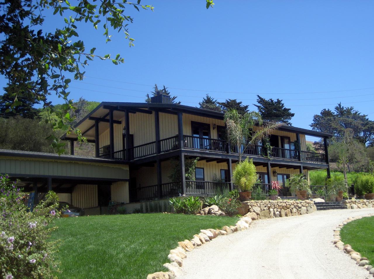 340 Toro Canyon Road Carpinteria, CA 93013 - Photo 2 of 4 a front view of a house with a garden