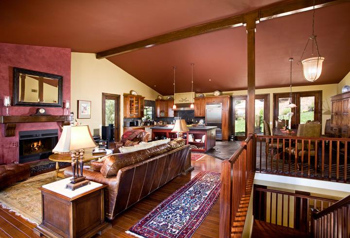 340 Toro Canyon Road Carpinteria, CA 93013 - Photo 3 of 4 a living room with furniture a fireplace and a floor to ceiling window