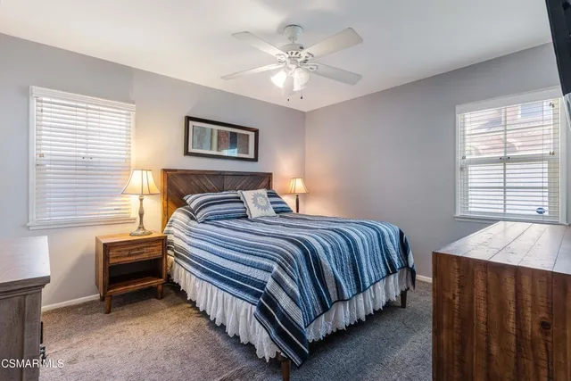 a bedroom with a bed and a table with window