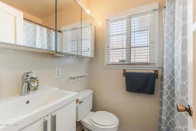 a bathroom with a sink a toilet and bathtub