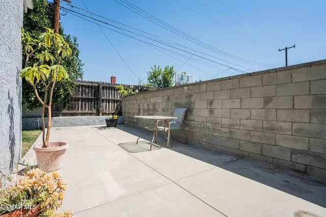 a view of a patio with table and chairs and potted plants