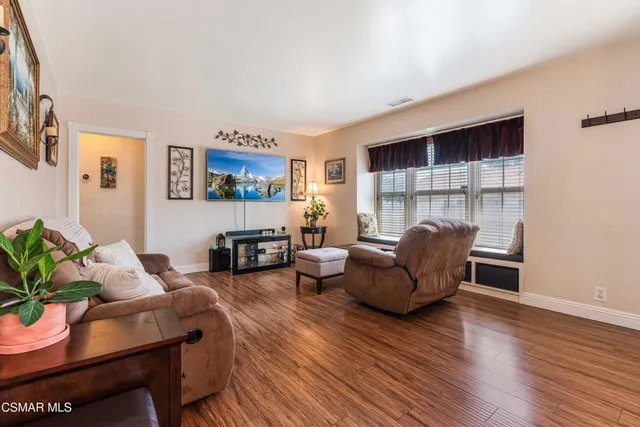 a living room with fireplace furniture and a wooden floor