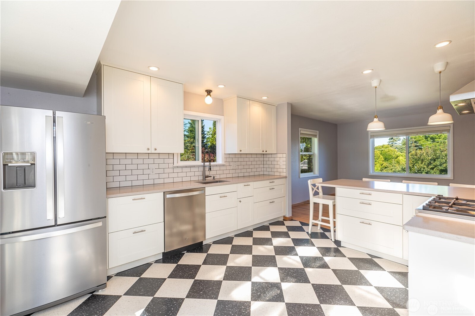 8601 36th Avenue Southwest Seattle, WA 98126 - Photo 12 of 28 a kitchen with a checkered floor and white cabinets