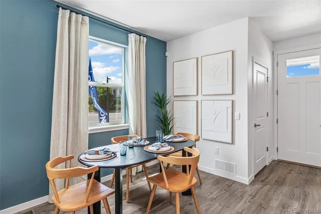 a view of a dining room with furniture and window