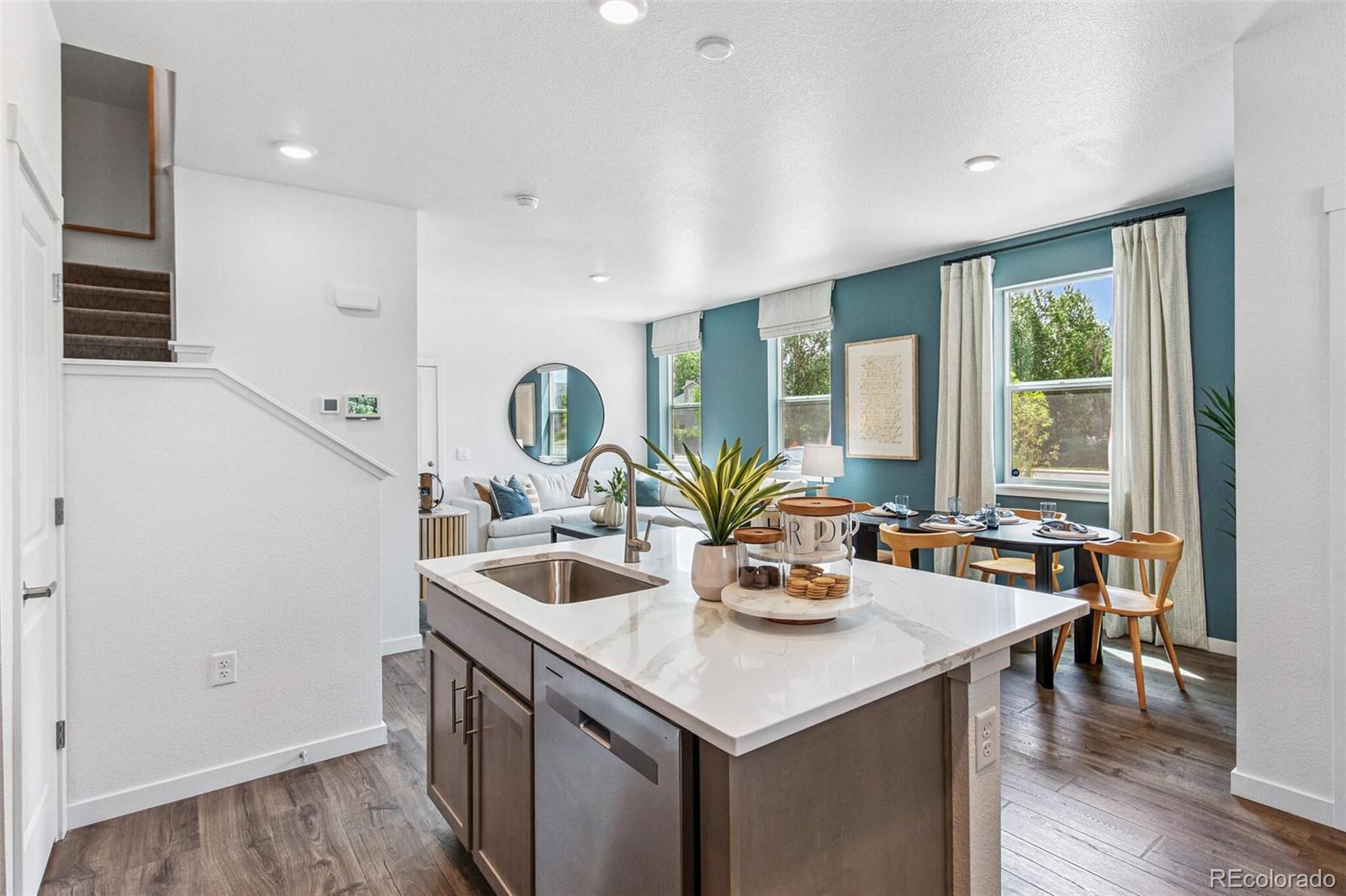 1373 South Chester Street, Unit A Denver, CO 80247 - Photo 8 of 28 a kitchen with a sink and wooden cabinets