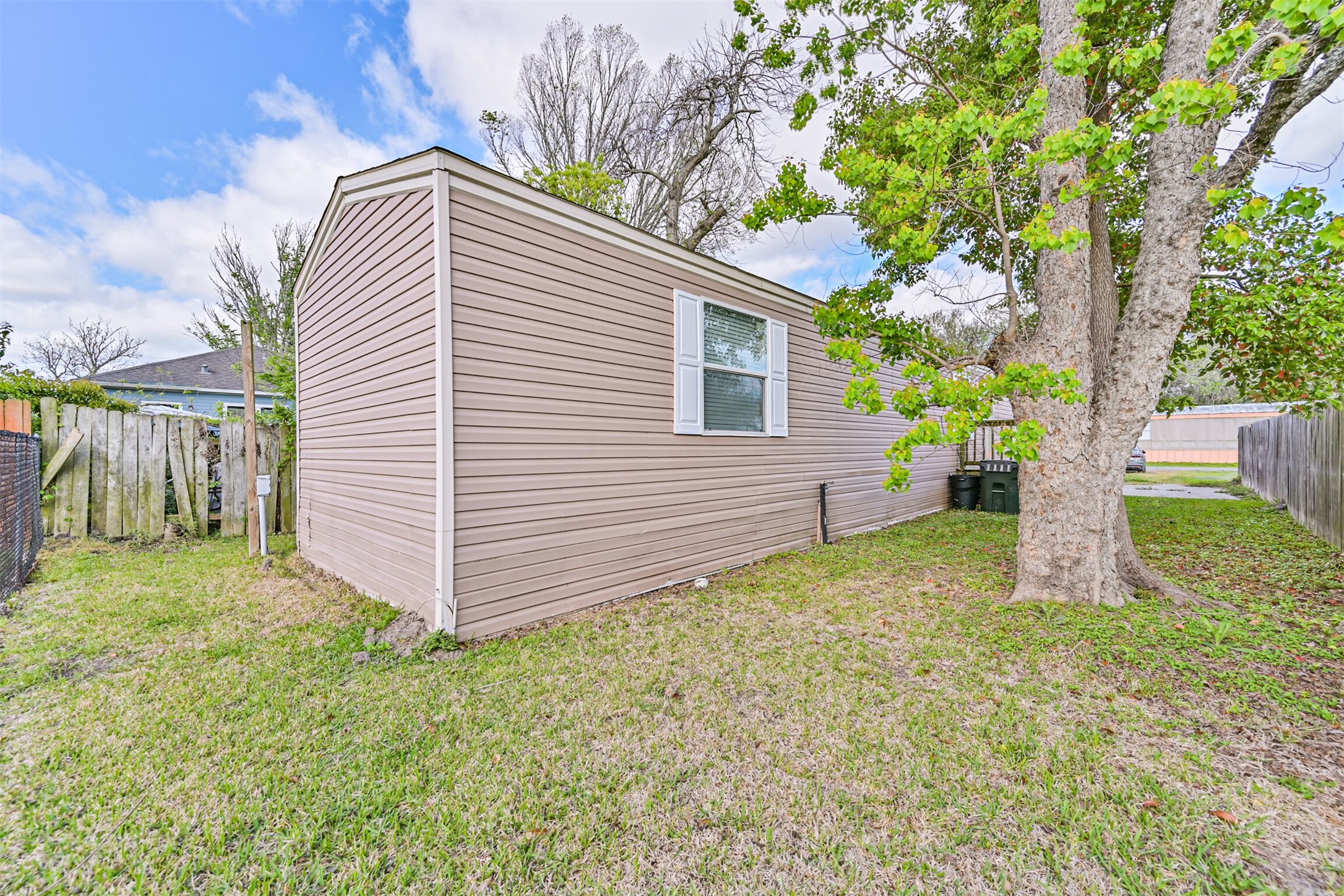 4702 10th Street Bacliff, TX 77518 - Photo 5 of 33 a white house that has a tree in front of the house