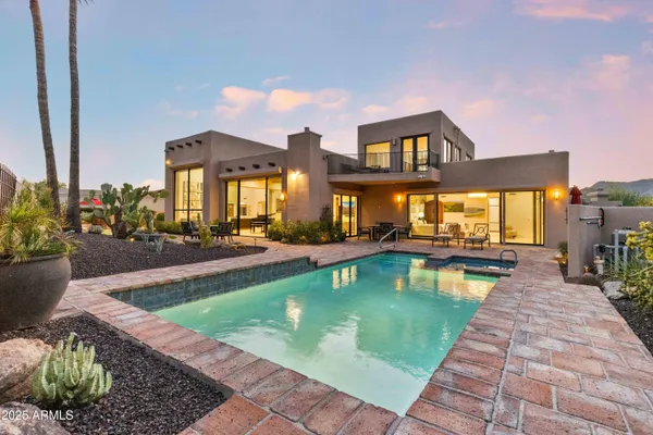 a view of swimming pool that has lawn chairs wooden floor and a potted plant