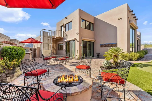 a view of a house with backyard porch and sitting area