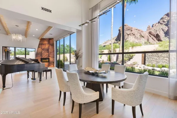 a living room with furniture a chandelier and a large window