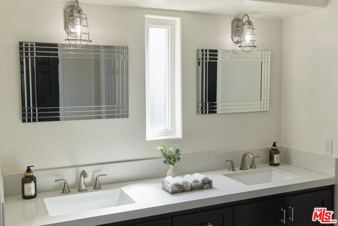 13230 Creekside Lane Poway, CA 92064 - Photo 11 of 23 a bathroom with a sink and a mirror