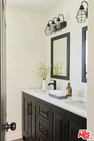 a bathroom with a sink a mirror and shower