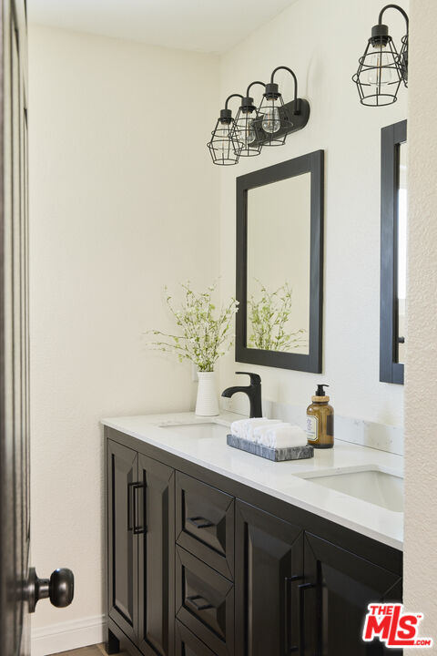13230 Creekside Lane Poway, CA 92064 - Photo 15 of 23 a bathroom with a sink and a mirror