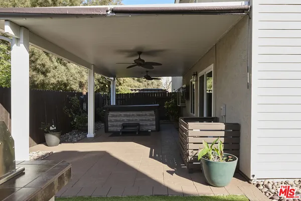 a view of a deck with table and chairs and wooden fence