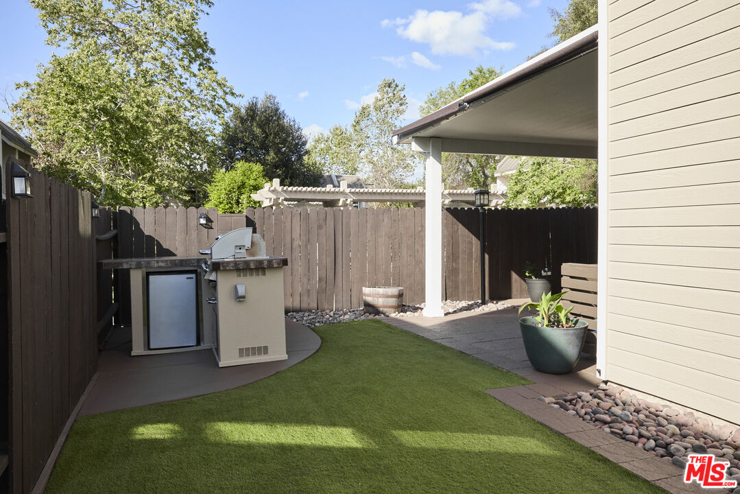 13230 Creekside Lane Poway, CA 92064 - Photo 23 of 23 a view of a deck with table and chairs and wooden fence