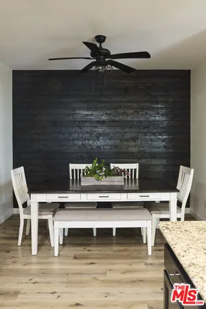 a kitchen with kitchen island granite countertop a sink stainless steel appliances and cabinets