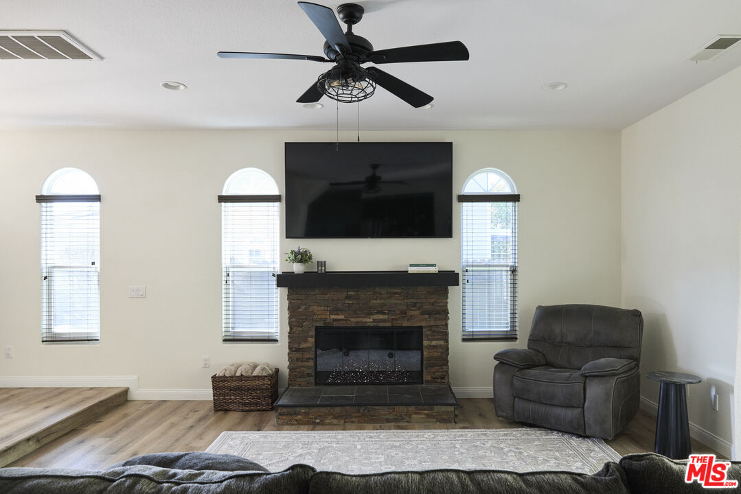 13230 Creekside Lane Poway, CA 92064 - Photo 6 of 23 a living room with furniture a flat screen tv and a fireplace