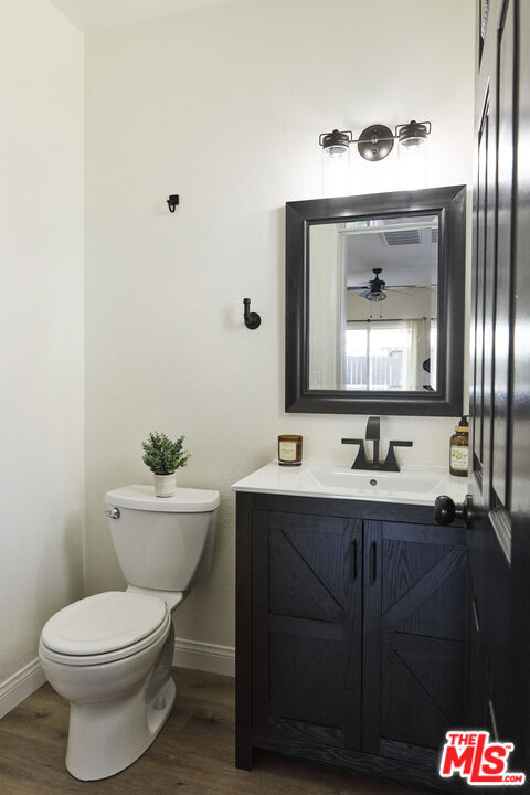 13230 Creekside Lane Poway, CA 92064 - Photo 7 of 23 a bathroom with a toilet a sink and mirror