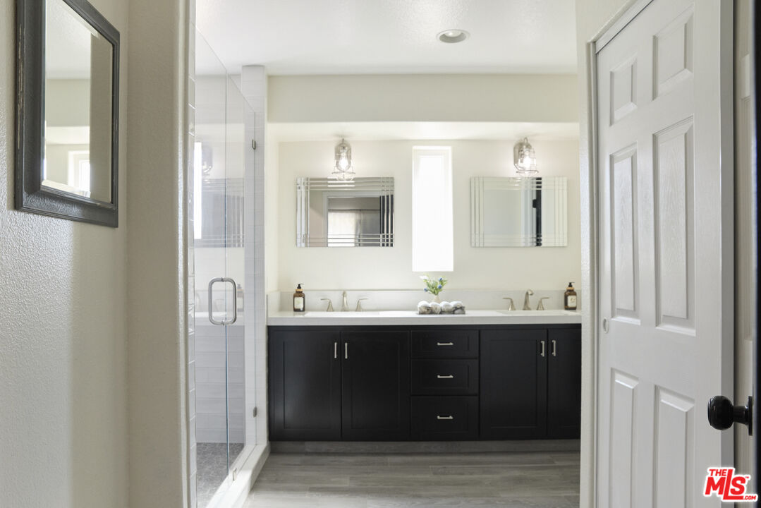 13230 Creekside Lane Poway, CA 92064 - Photo 10 of 23 a bathroom with a double vanity sink and mirror