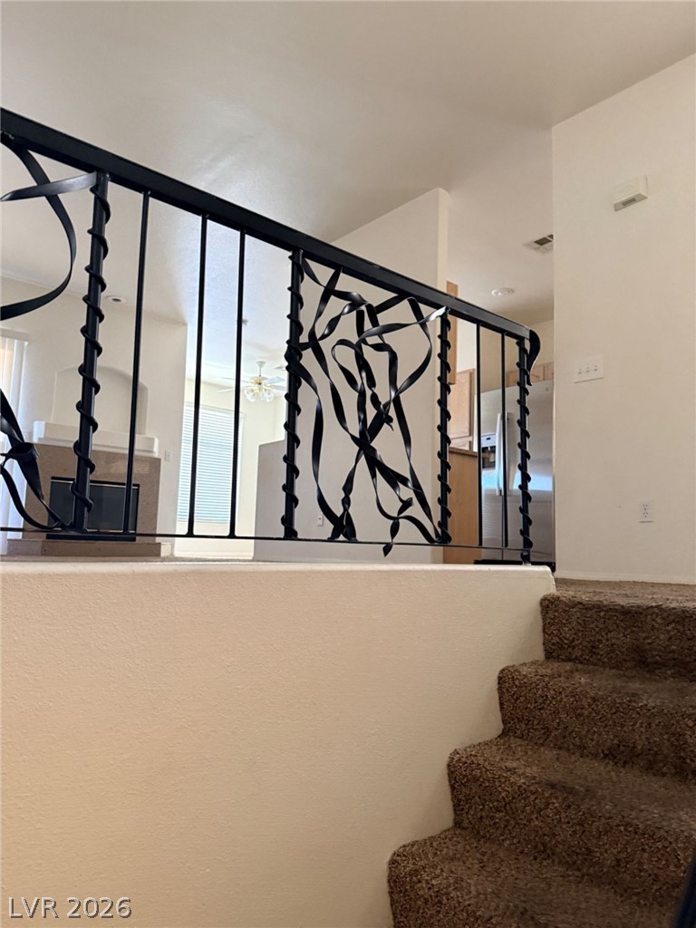 2050 West Warm Springs Road, Unit 3521 Henderson, NV 89014 - Photo 3 of 12 Artfully crafted iron railings guide the way up carpeted steps.