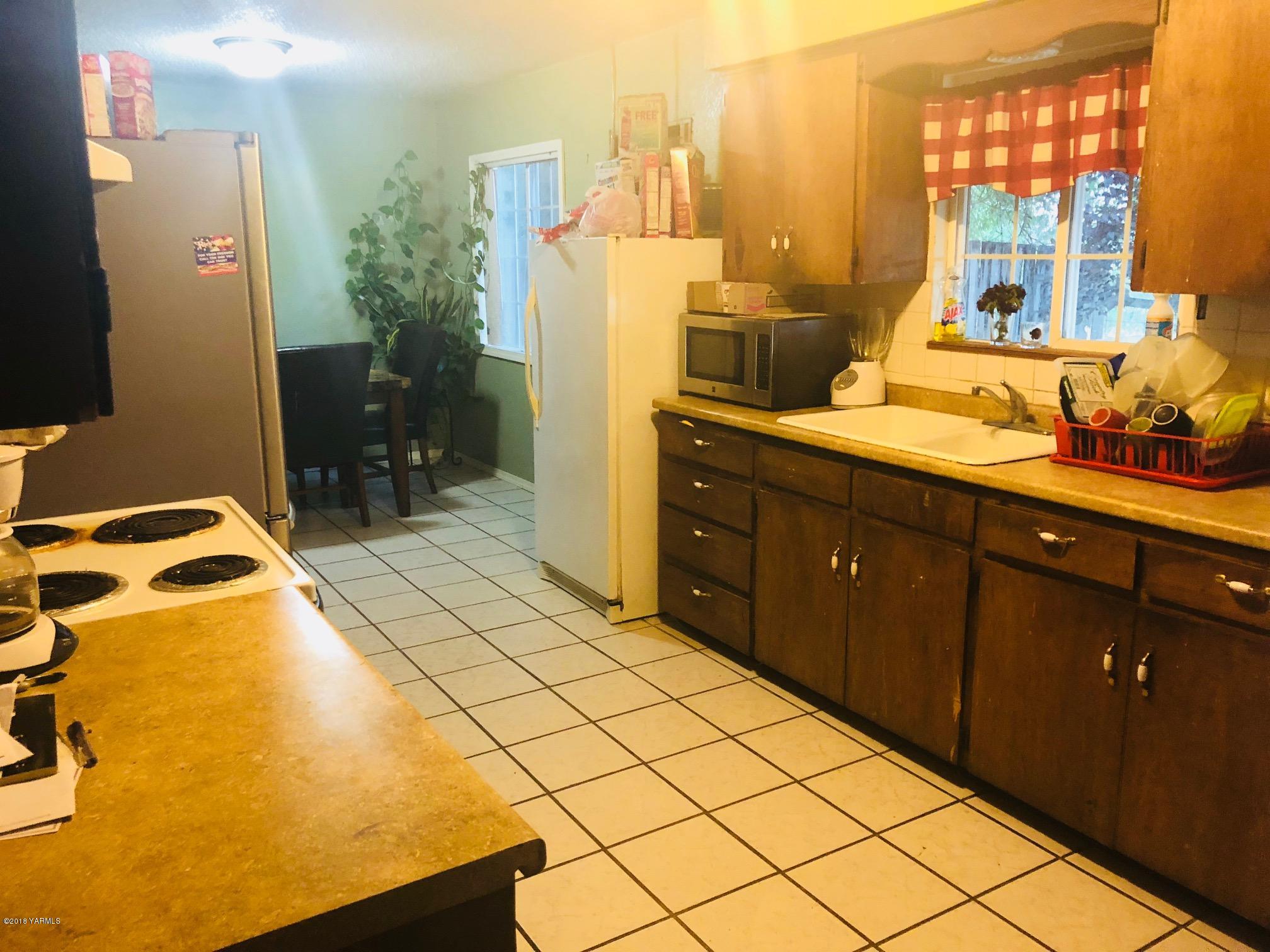 908 North Euclid Road Grandview, WA 98930 - Photo 5 of 16 a bedroom with a bed and wooden floor