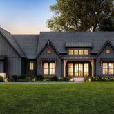 a front view of a house with a garden and yard