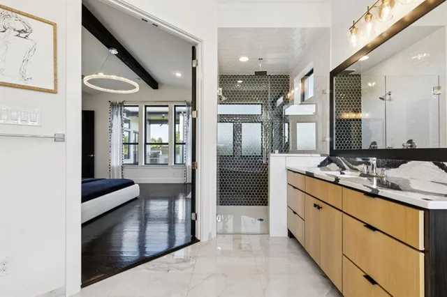 a bathroom with a tub sink and mirror