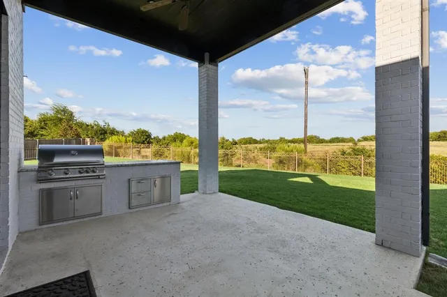a kitchen with stainless steel appliances granite countertop a sink and a refrigerator