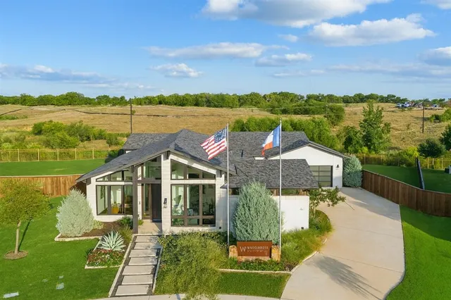 a view of a house with a yard and balcony