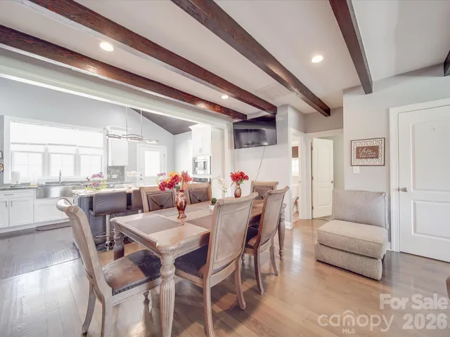 a living room with fireplace furniture and a chandelier