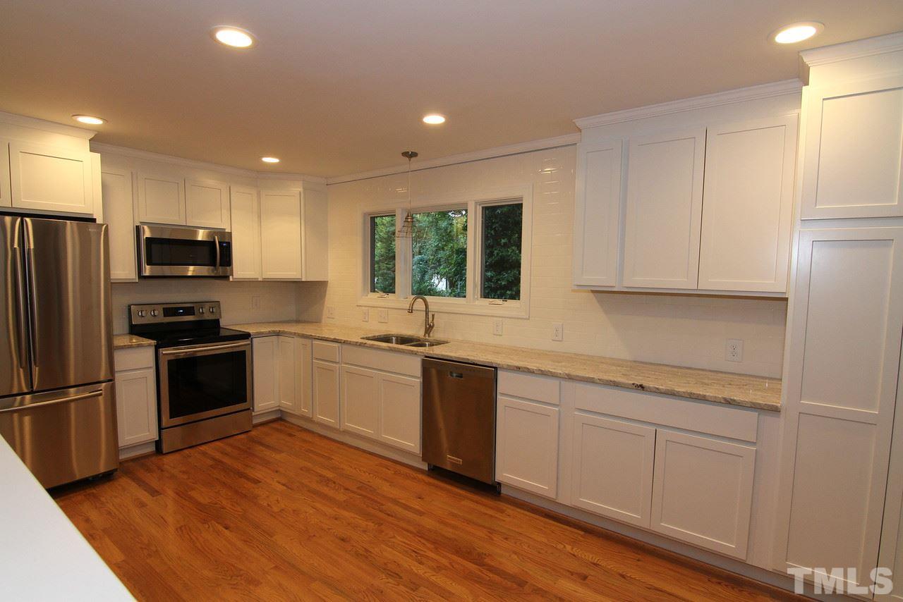 4208 Rowan Street Raleigh, NC 27609 - Photo 4 of 14 a kitchen with a refrigerator stove and microwave