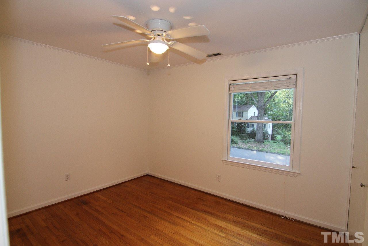 4208 Rowan Street Raleigh, NC 27609 - Photo 7 of 14 an empty room with wooden floor and windows