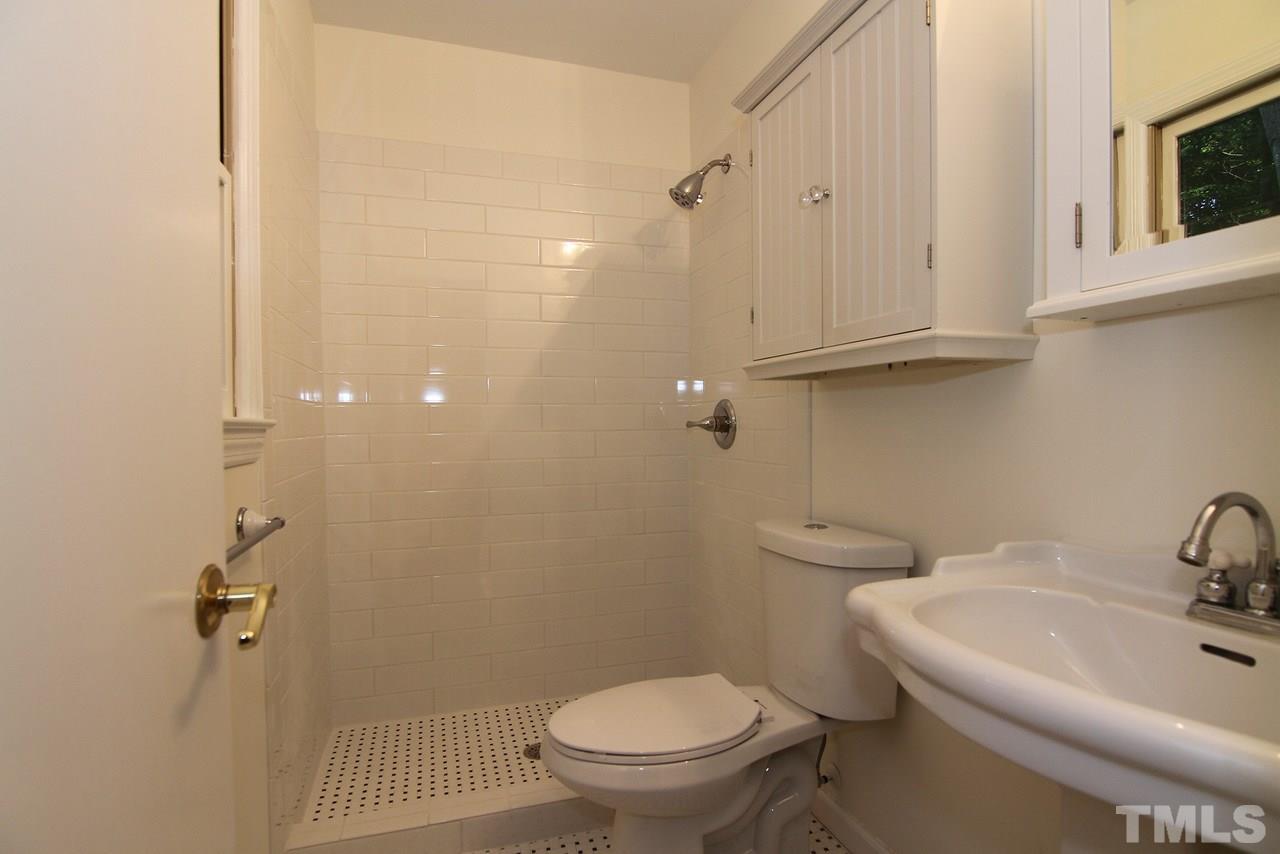 4208 Rowan Street Raleigh, NC 27609 - Photo 8 of 14 a bathroom with a sink a toilet and shower