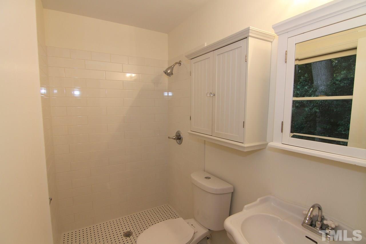 4208 Rowan Street Raleigh, NC 27609 - Photo 9 of 14 a bathroom with a toilet a sink and shower